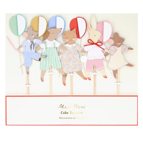 Packaging for Meri Meri cake toppers featuring dressed animal figures holding colorful balloons.