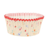 Paper cupcake liner featuring a delicate floral pattern and a scalloped red rim.