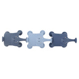Three toy elephants in shades of blue are lined up horizontally. Each elephant has a rounded body and a cute, smiling face, evoking playful charm.