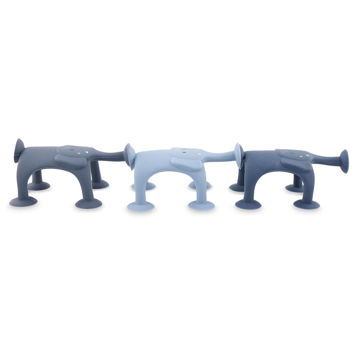 Three dog-shaped silicone kitchen sponges in varying shades of blue, featuring suction cup legs and cartoon-like faces, create a playful tone.