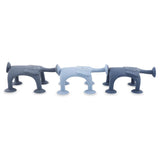 Three dog-shaped silicone kitchen sponges in varying shades of blue, featuring suction cup legs and cartoon-like faces, create a playful tone.