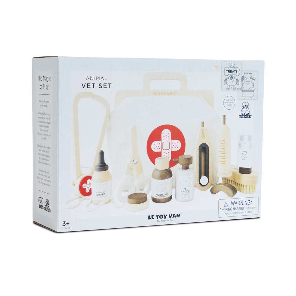 Children's vet play set from Le Toy Van displayed on packaging. Includes pretend medical tools and bottles, emphasizing imaginative play for ages 3+.