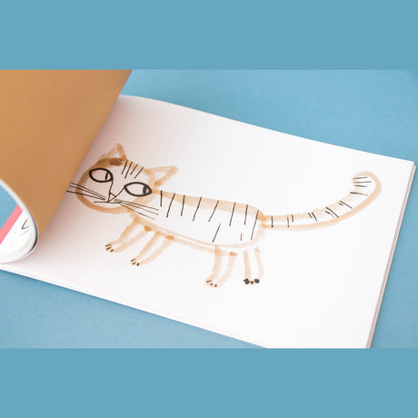 Whimsical watercolor illustration of a striped cat in a Londji art activity book, featuring simple brown and black strokes.
