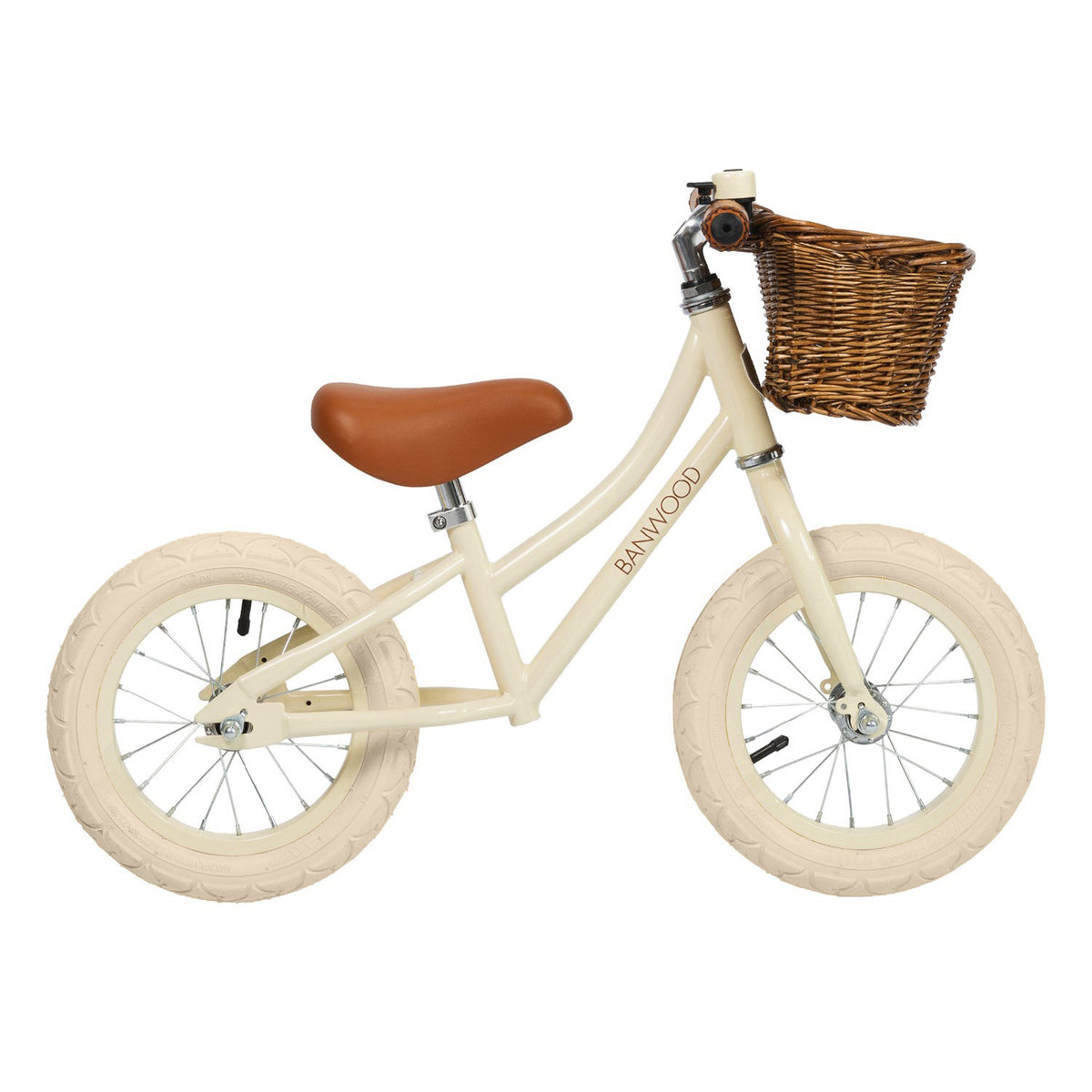 A stylish kids' balance bike with a cream-colored frame, adjustable saddle and handlebars, and a classic wicker basket for timeless charm.