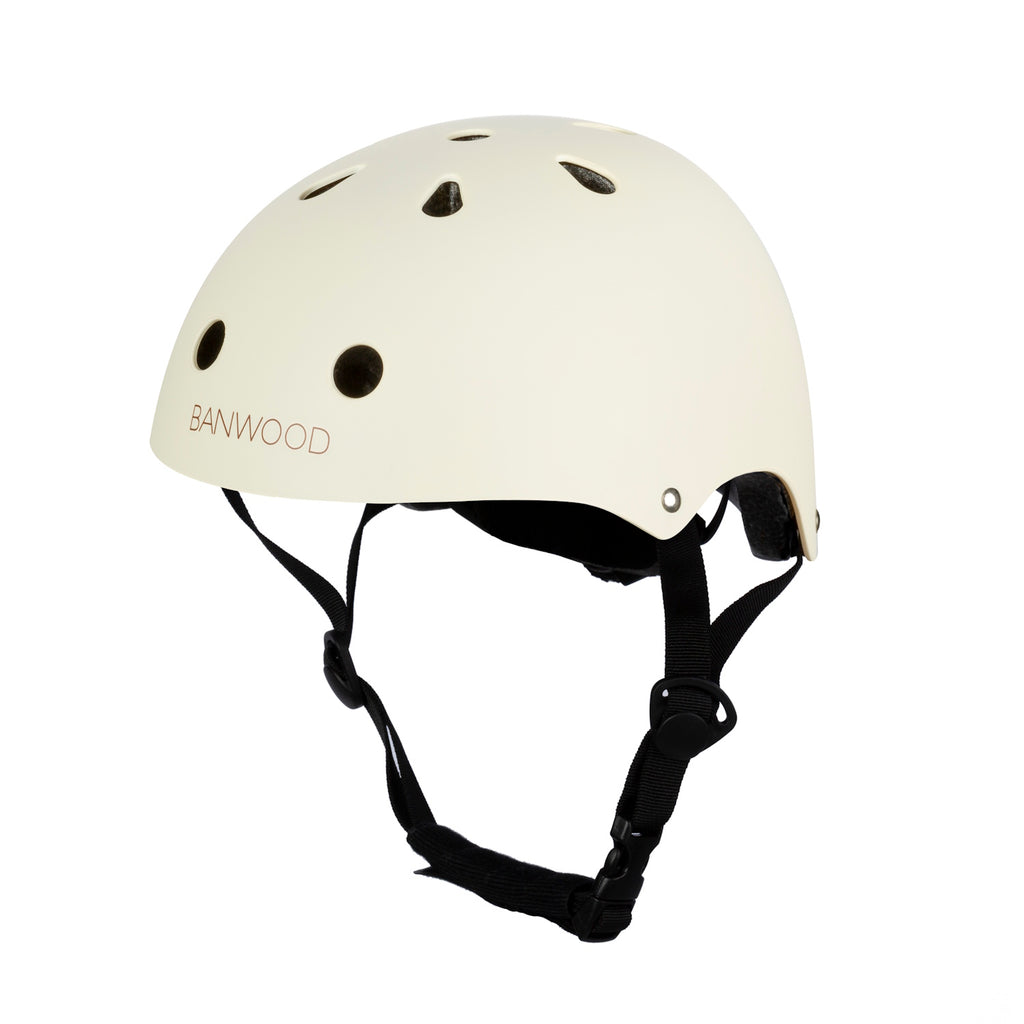 A stylish and durable kids’ bike helmet in a soft cream color, featuring an adjustable chin strap and ventilation for safety and comfort.