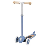 Banwood kids scooter in blue angled view showing wooden deck, T-bar handles, and three white wheels on white background.