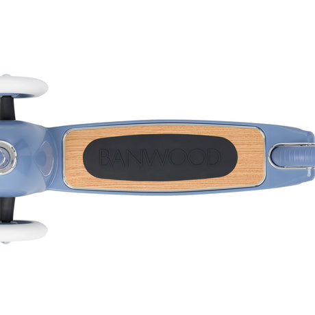 Banwood scooter blue deck top view showing natural wood surface with black rubber grip and Banwood logo.