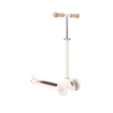 A stylish vintage-style kids' scooter in a soft cream color, featuring three wheels for stability and adjustable handlebar.