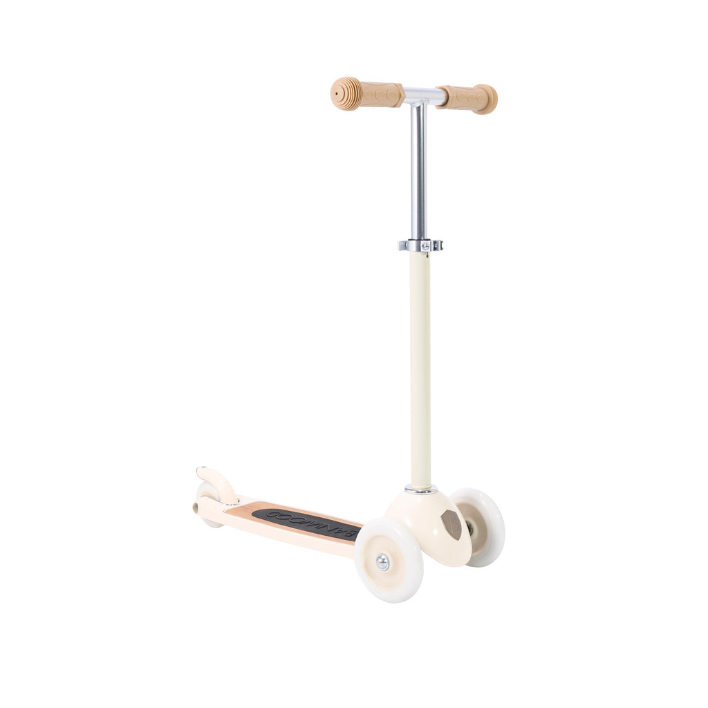 A stylish vintage-style kids' scooter in a soft cream color, featuring three wheels for stability and adjustable handlebar.