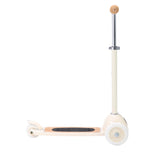 A stylish vintage-style kids' scooter in a soft cream color, featuring three wheels for stability and adjustable handlebar.