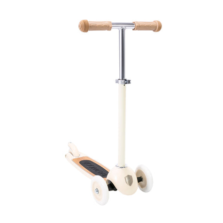 A stylish vintage-style kids' scooter in a soft cream color, featuring three wheels for stability and adjustable handlebar.
