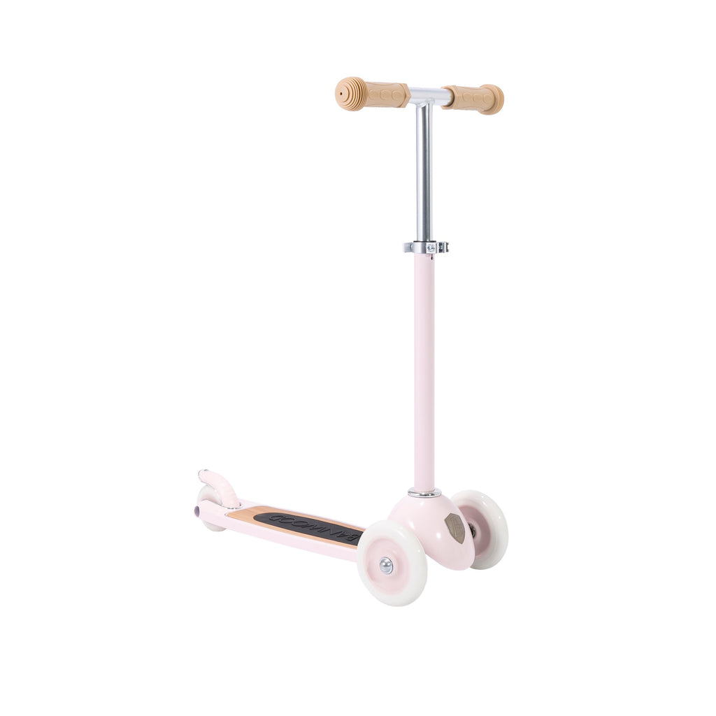 A charming retro-style kids' scooter in pastel pink, featuring three wheels for balance and adjustable handlebar.