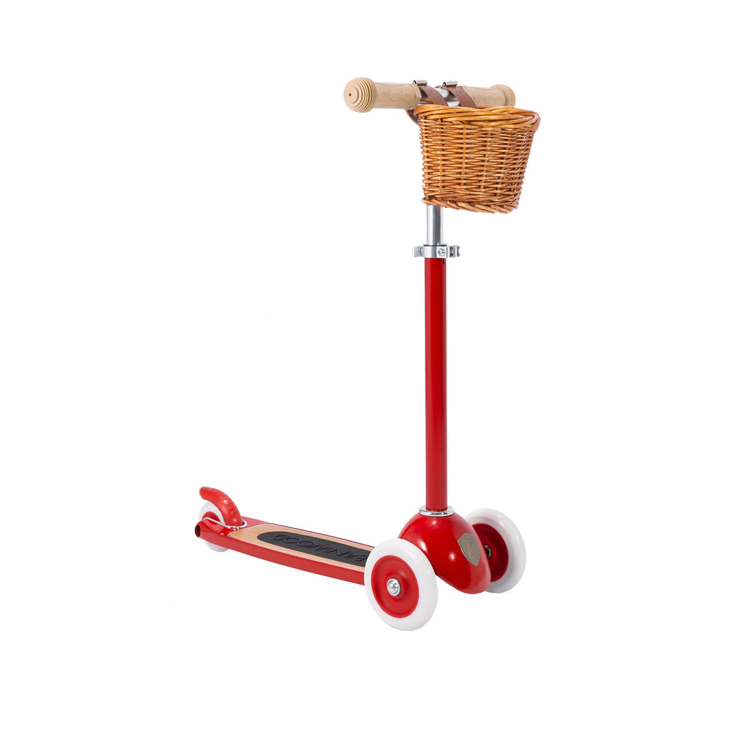 A retro-inspired kids' scooter with a bright red frame, three wheels for stability, an adjustable T-handlebar, and a detachable wicker basket.