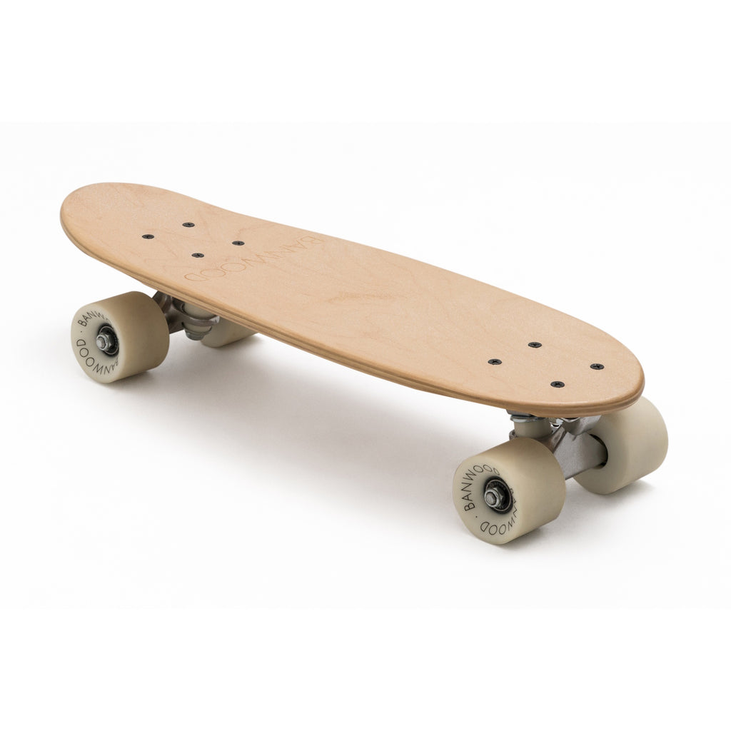A minimalist cruiser skateboard with a natural wood finish, soft wheels, and a classic design, perfect for young riders and smooth cruising.