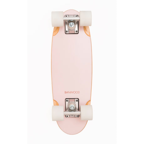 A vintage-inspired cruiser skateboard featuring a pastel pink deck, soft wheels, and a durable maple wood finish, perfect for young beginners.