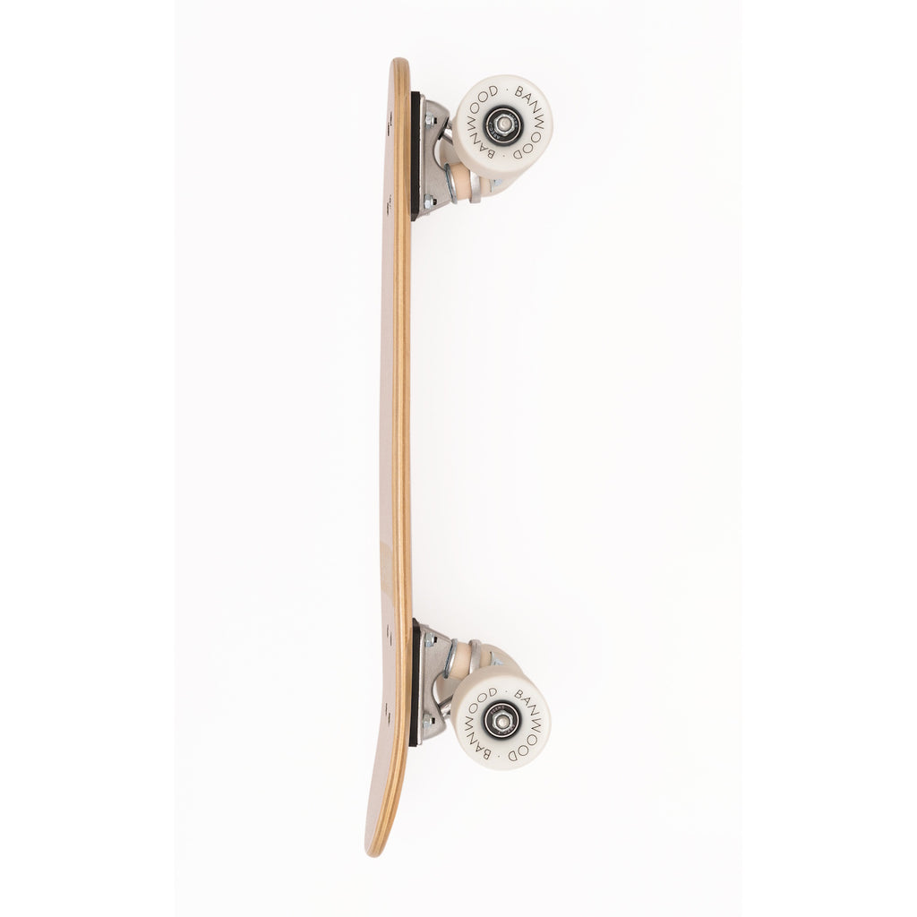 A vintage-inspired cruiser skateboard featuring a pastel pink deck, soft wheels, and a durable maple wood finish, perfect for young beginners.