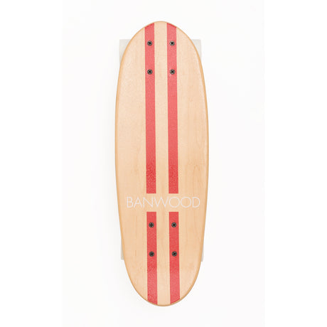 A retro-style cruiser skateboard with a bold red deck, soft wheels, and a sturdy maple wood construction, designed for smooth rides and young skaters.