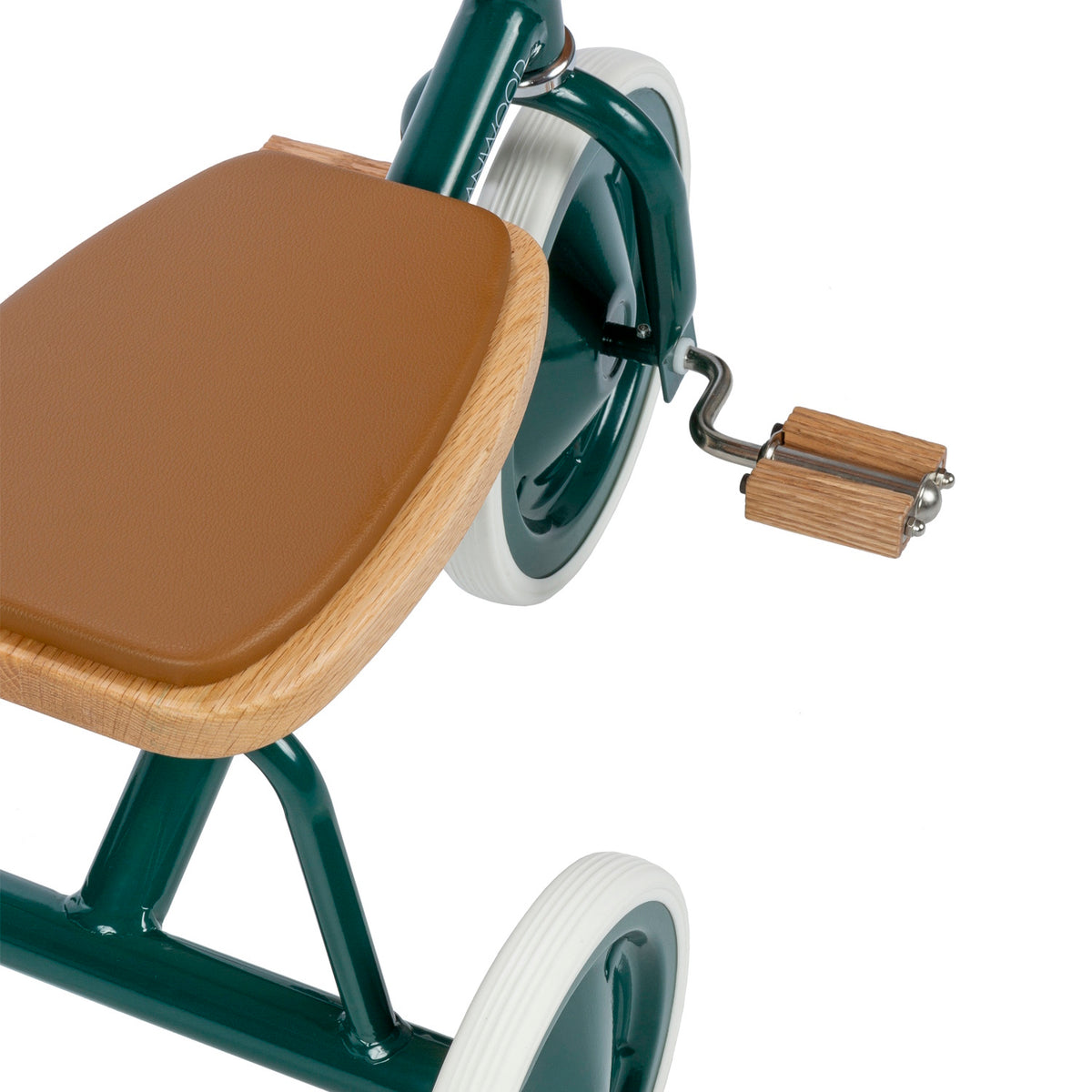 Top view close-up of a green Banwood tricycle showing its oak wooden seat and pedal.