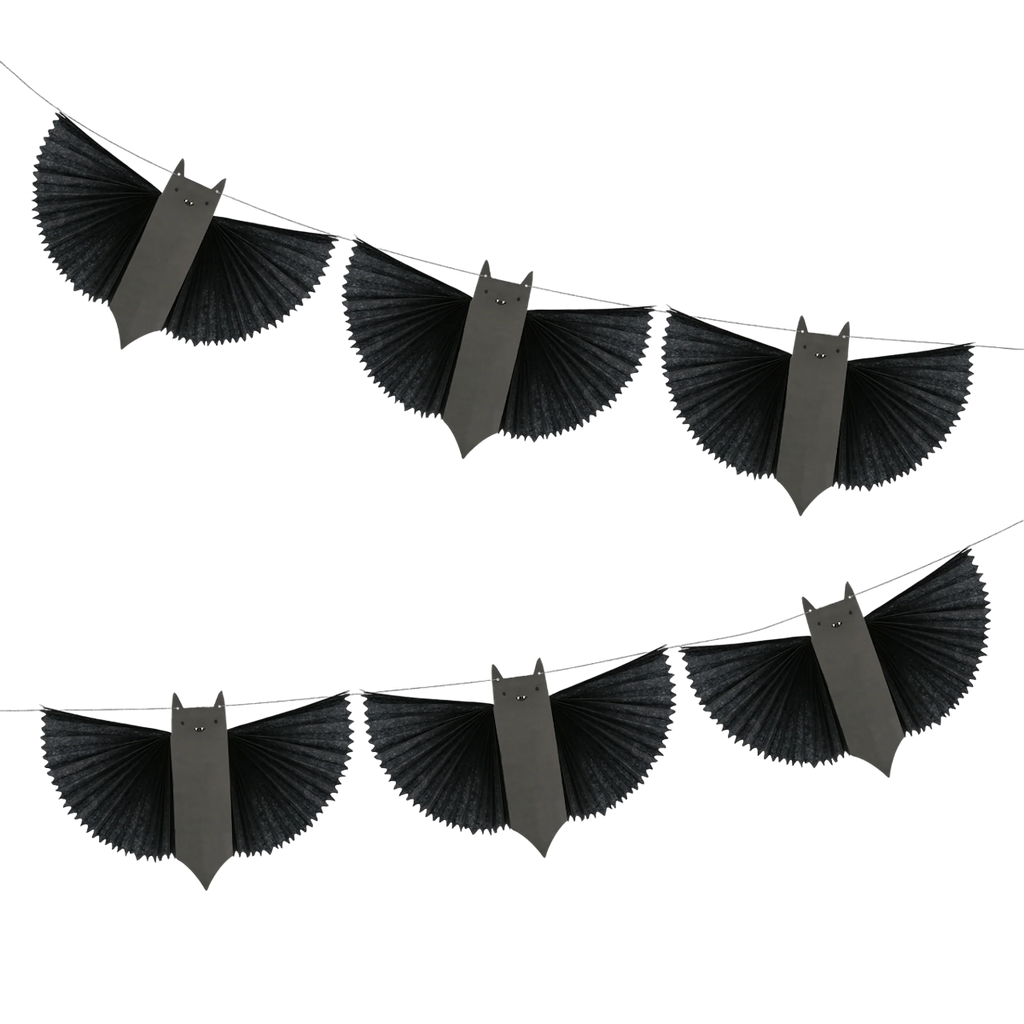 Garland of paper bats with pleated wings arranged diagonally against a white background. The bats convey a Halloween theme with a whimsical tone.