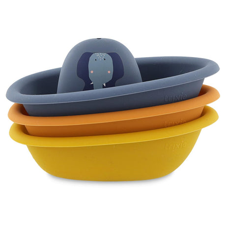 Three stacked silicone toy boats in blue, orange, and yellow with an elephant illustration on the top boat.