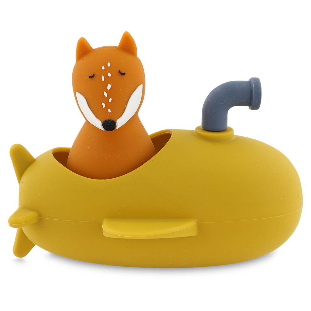 A cute orange fox toy with eyes closed sits in a yellow submarine-shaped bath toy, featuring a small periscope. The tone is playful and whimsical.