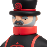 Toy figure with a serious expression, wearing a black top hat and coat with red accents, featuring a curled mustache and gray beard, on a white background.