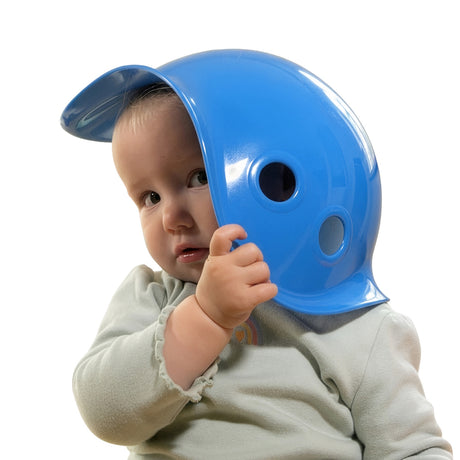 A baby peeks out from behind a bright blue Bilibo Mini toy shell against a white background for open-ended play.