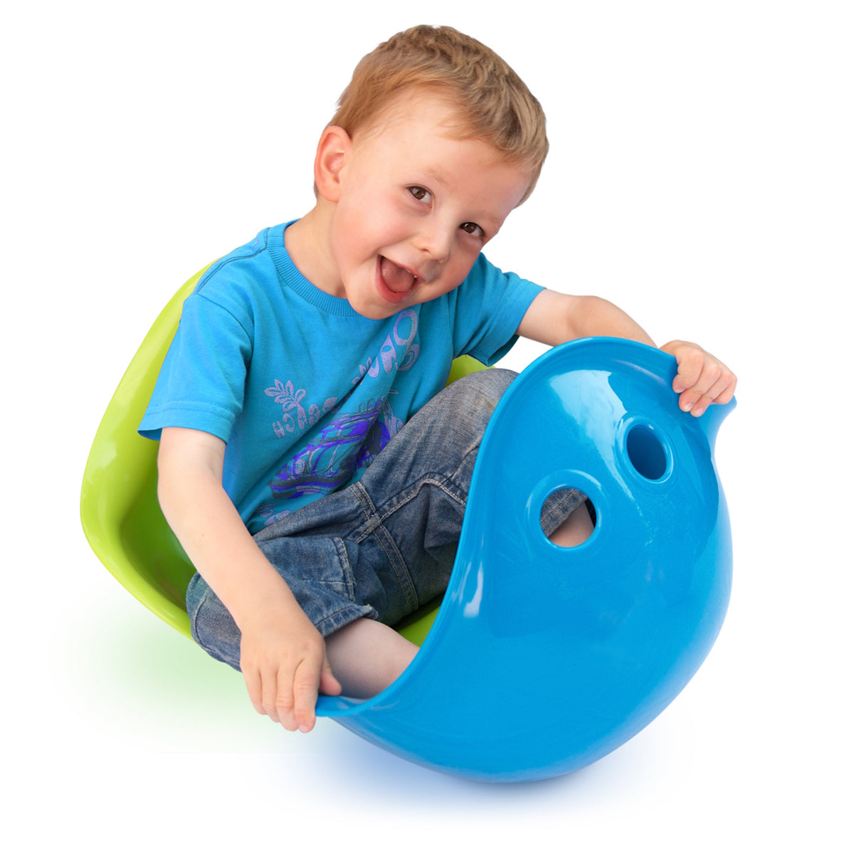 Smiling young boy playing with blue and green Bilibo sensory toys against a white background.