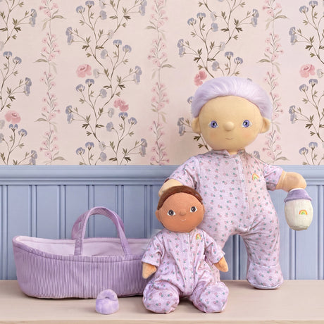 Olli Ella Dinkum Doll Pip and Dinky Dinkum doll in matching floral pajamas with a purple basket.