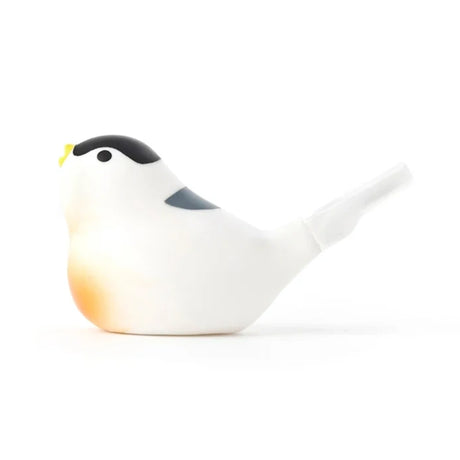 A minimalist bird-shaped whistle with a black head, yellow beak, and white body, featuring a subtle orange tint on the chest. The design is sleek and contemporary.