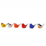 Six colorful bird-shaped whistles are lined up against a white background. Each bird is uniquely painted in vivid hues like yellow, orange, red, blue, and black.