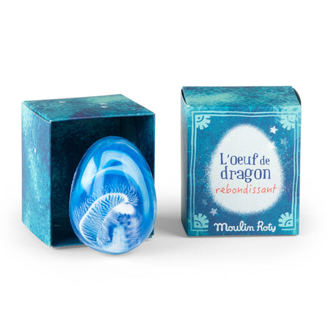 Blue marbled dragon egg bouncy ball toy by Moulin Roty next to its decorative blue box.