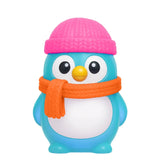 NeeDoh Polar Glow Penguin squishy toy in blue with a pink knit hat and orange scarf on a white background.
