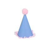 Blue mini party hat with a pink pom-pom and fringe trim on a white background.