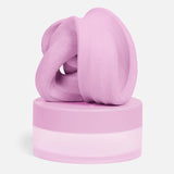 Swirled soft-pink focus putty resting on top of its matching circular container.
