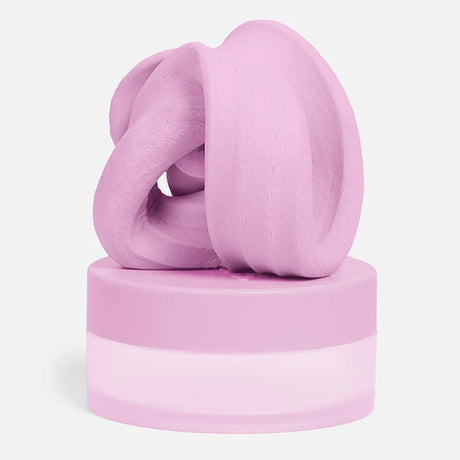 Swirled soft-pink focus putty resting on top of its matching circular container.