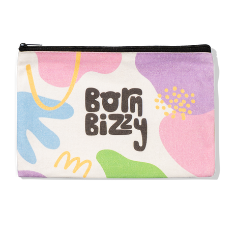 Canvas pouch with a black zipper featuring the text "born bizzy" surrounded by colorful abstract shapes.