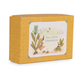 Yellow patterned gift box featuring a rabbit and turtle illustration with the text "Mes petits chaussons."