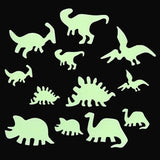 Glow-in-the-dark dinosaur silhouettes on a black background, featuring Triceratops, Stegosaurus, and Pterodactyl, conveying a playful tone.