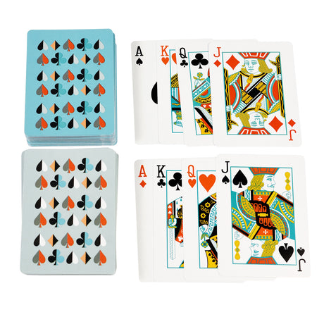 A deck of playing cards laid out, featuring colorful designs and various ranks, including Aces and Kings, alongside a stacked card deck.