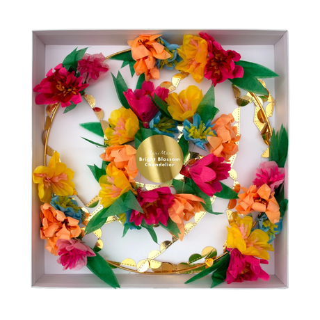 Packaged floral party chandelier with colorful paper flowers and gold foil details inside a white box.