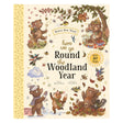 Book cover for 'Here We Go Round the Woodland Year' featuring illustrated woodland animals in four seasons.
