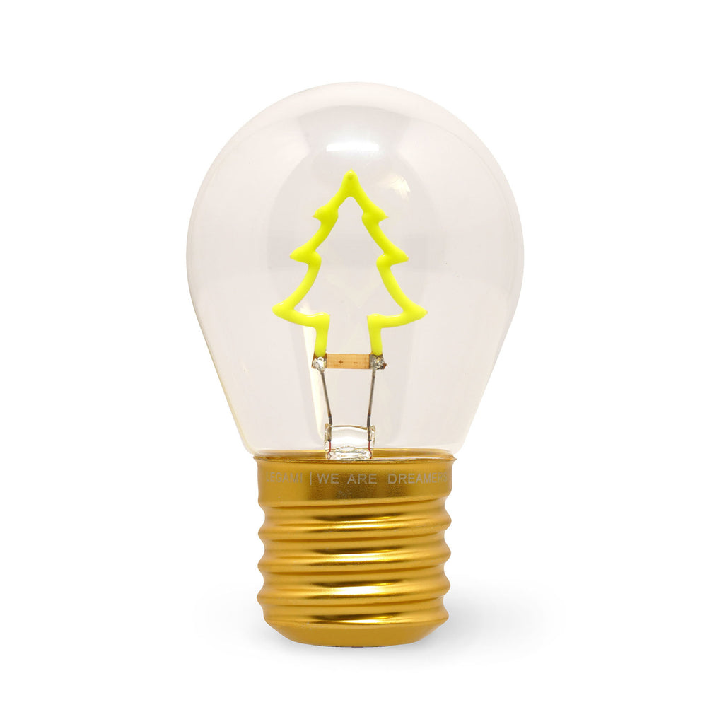 A clear light bulb with a gold base features a neon green Christmas tree-shaped filament inside, conveying a festive and creative ambiance.