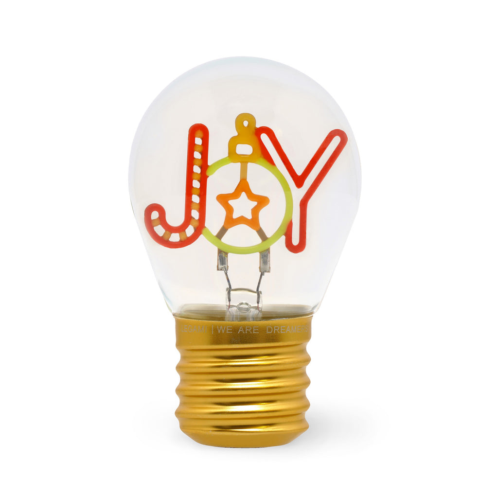 A light bulb with the word "JOY" in colorful, playful letters. The "O" resembles a holiday ornament with a star inside, evoking a festive mood.