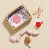 Wooden toy crate and scattered play food meats on a beige background.