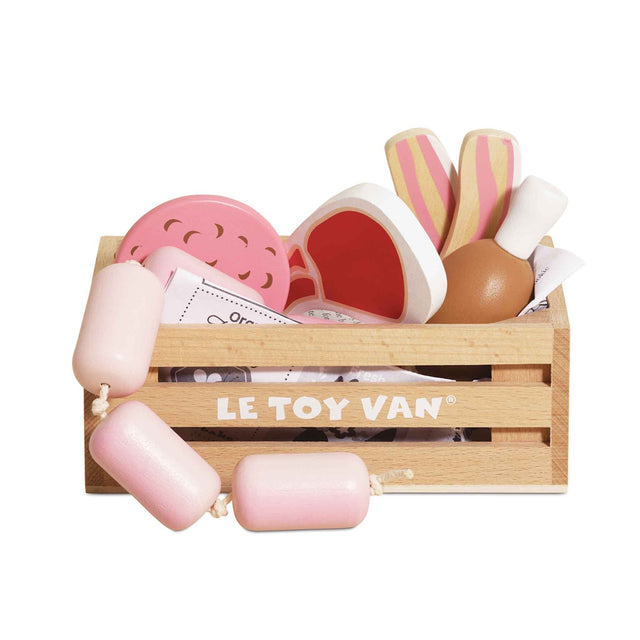 Wooden crate filled with toy meats and sausages on a white background.