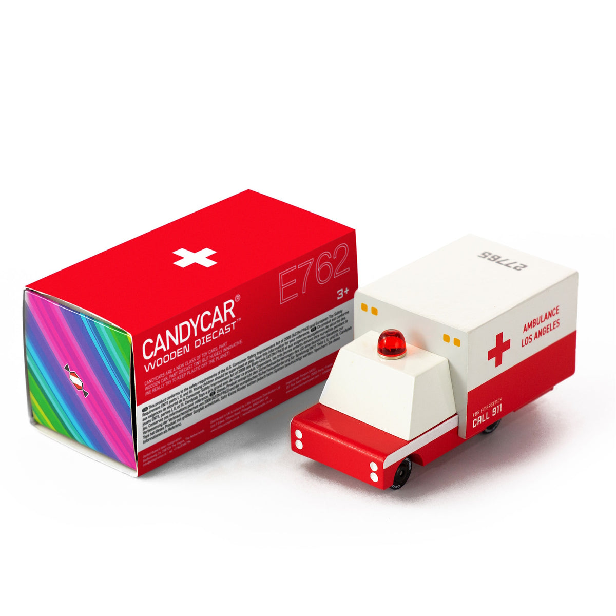 Wooden Candylab Candycar ambulance toy with red light and Los Angeles decals next to its red and white box.