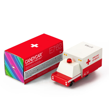 Wooden Candylab Candycar ambulance toy with red light and Los Angeles decals next to its red and white box.