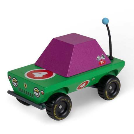 Colorful wooden toy truck with green body, purple cabin, and number 4 racing decals on chunky all-terrain tires.