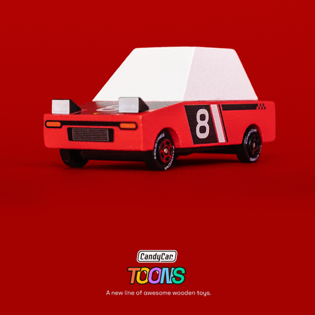 Red wooden Candycar Toons Hachigo racer toy with white roof, pop-up headlights, and number 8 on a vibrant red background.